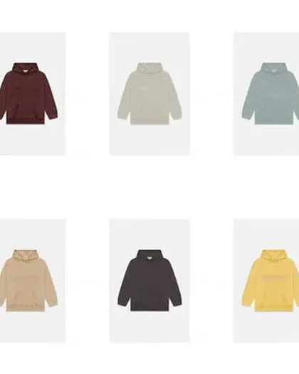 Six plain pullover hoodies laid out on white, in burgundy, cream, pale blue, sand, charcoal and yellow