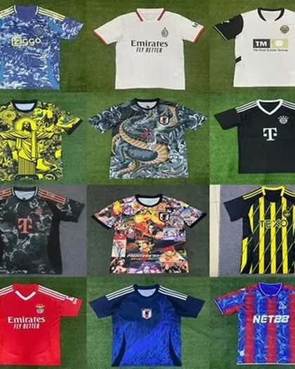 A grid of football shirts laid on grass, in white, navy, yellow, teal and red, several with sponsor blocks